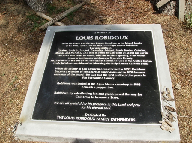 The memorial plaque which rests under what remains of the original Pepper tree that Louis was buried under.